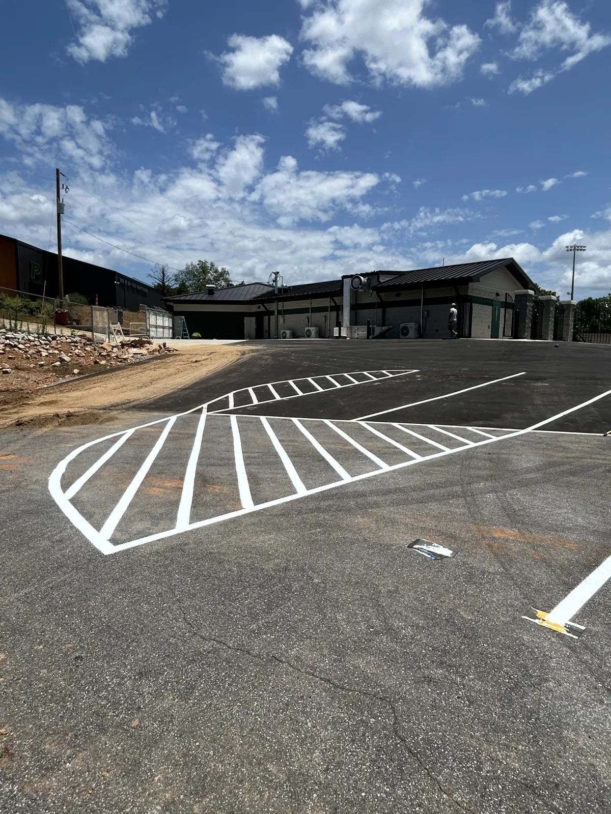 Crisp white crosshatched markings at an athletic facility entrance